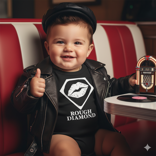 baby sitting at a diner wear a black onzie with Rough Diamond on it giving a thumbs up holding a juke box