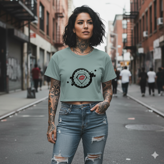 Woman wearing a light blue t-shirt with a graphic design on a city street.